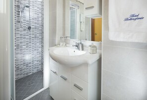 A modern bathroom with a shower, a sink, and a mirror. - Hotel Bellerofonte (Rimini)