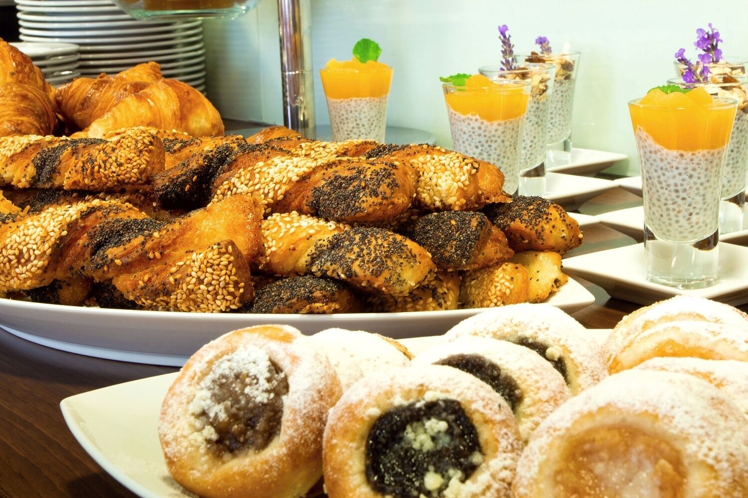 A variety of pastries including croissants and filled pastries on a table.