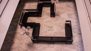 A geometric metal sculpture on a marble floor. - Hotel Keerthi (Thiruvananthapuram)