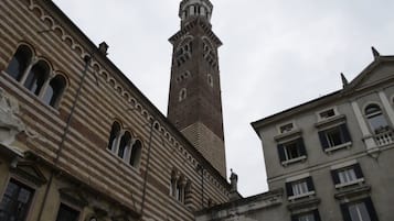 A historic building with a prominent tower featuring arched windows and a clock.