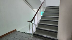 A staircase with metal railings and tiled steps. - Ease Hostel (Bangkok)
