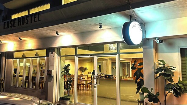 A hostel with a sign reading "FASE HOSTEL" and a large clock above the entrance. - Ease Hostel (Bangkok)
