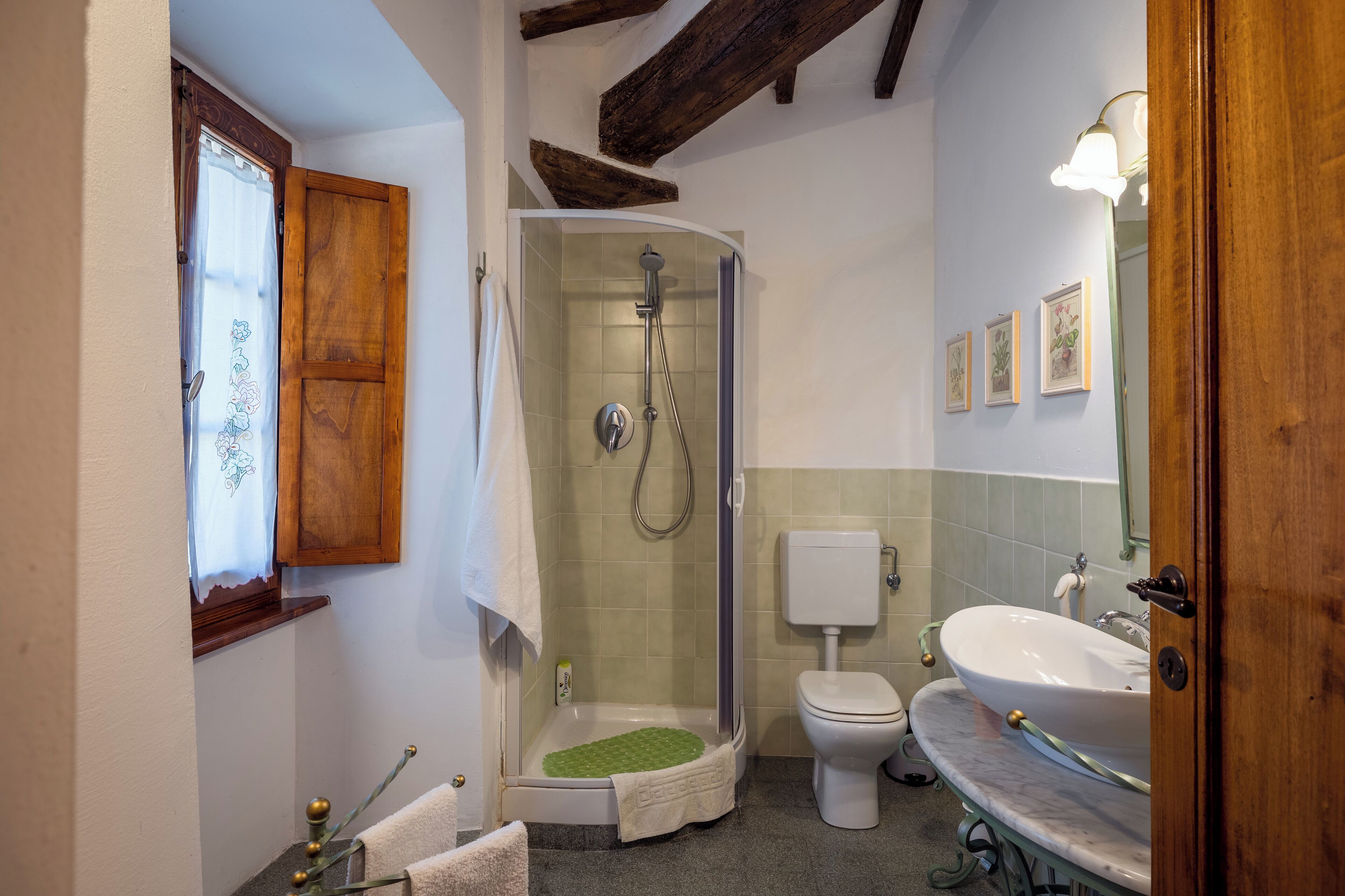 A bathroom with a shower, toilet, and sink.