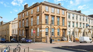 A historic building with multiple stories, large windows, and a prominent entrance. - Blythswood Square Apartments (Glasgow)