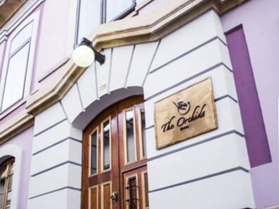 A building facade with a sign reading "The Orchid."