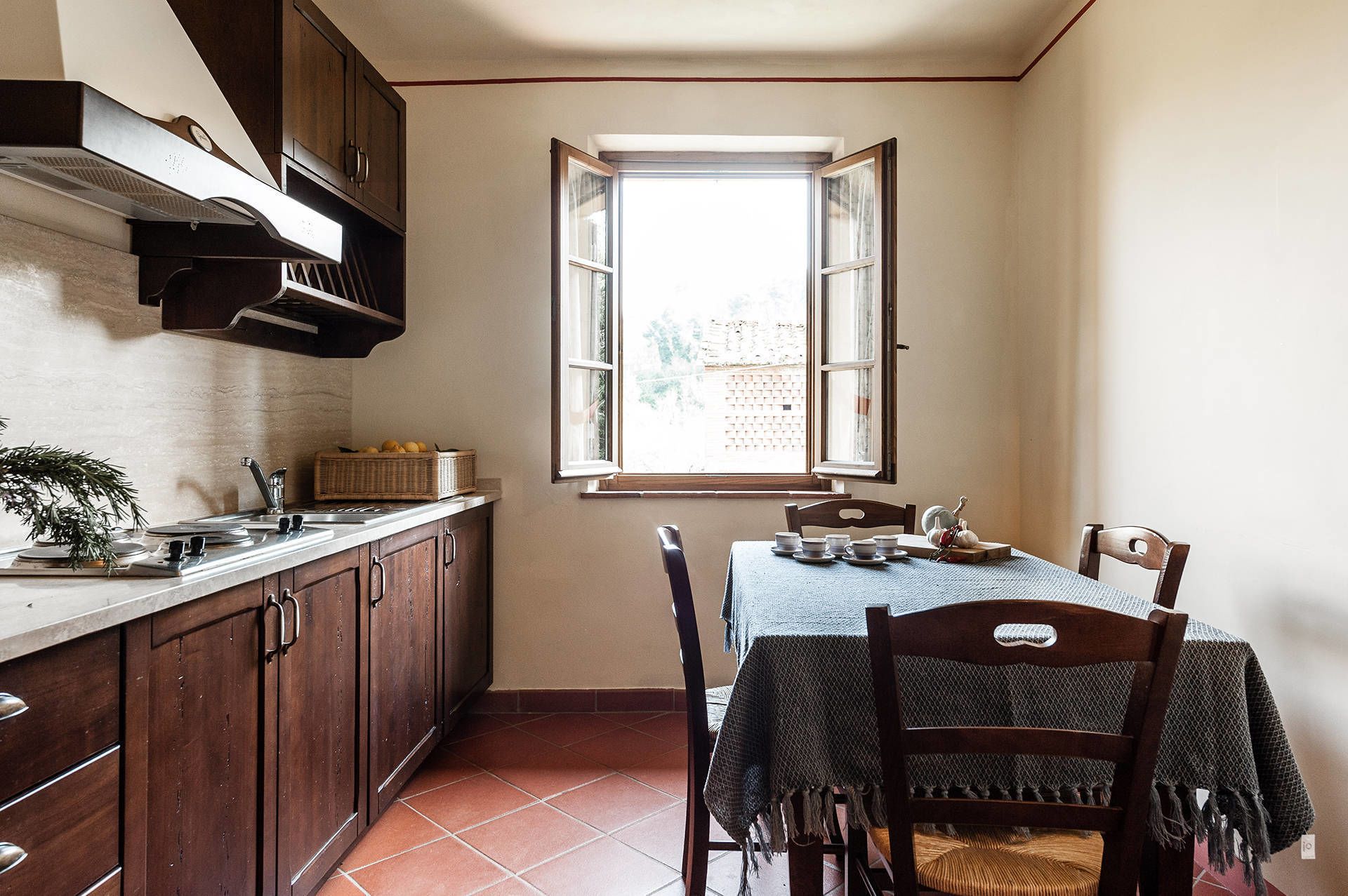 A kitchen with a dining table, chairs, and a window.
