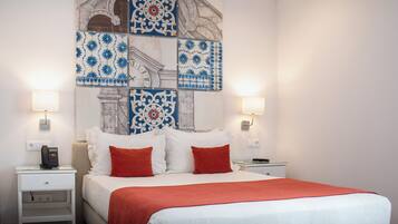 A hotel room with a large bed, two nightstands, a wall clock, and decorative tiles.