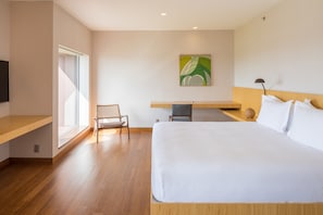 Relax in a spacious room with a large bed, desk, and flat-screen TV.