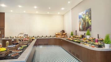 A buffet with various food items and a patterned floor.