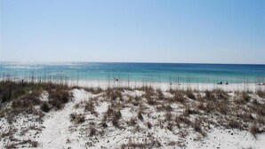 A beach with clear blue water and white sand.