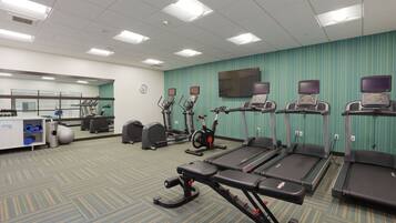 A fitness center with treadmills, elliptical machines, and exercise bikes.