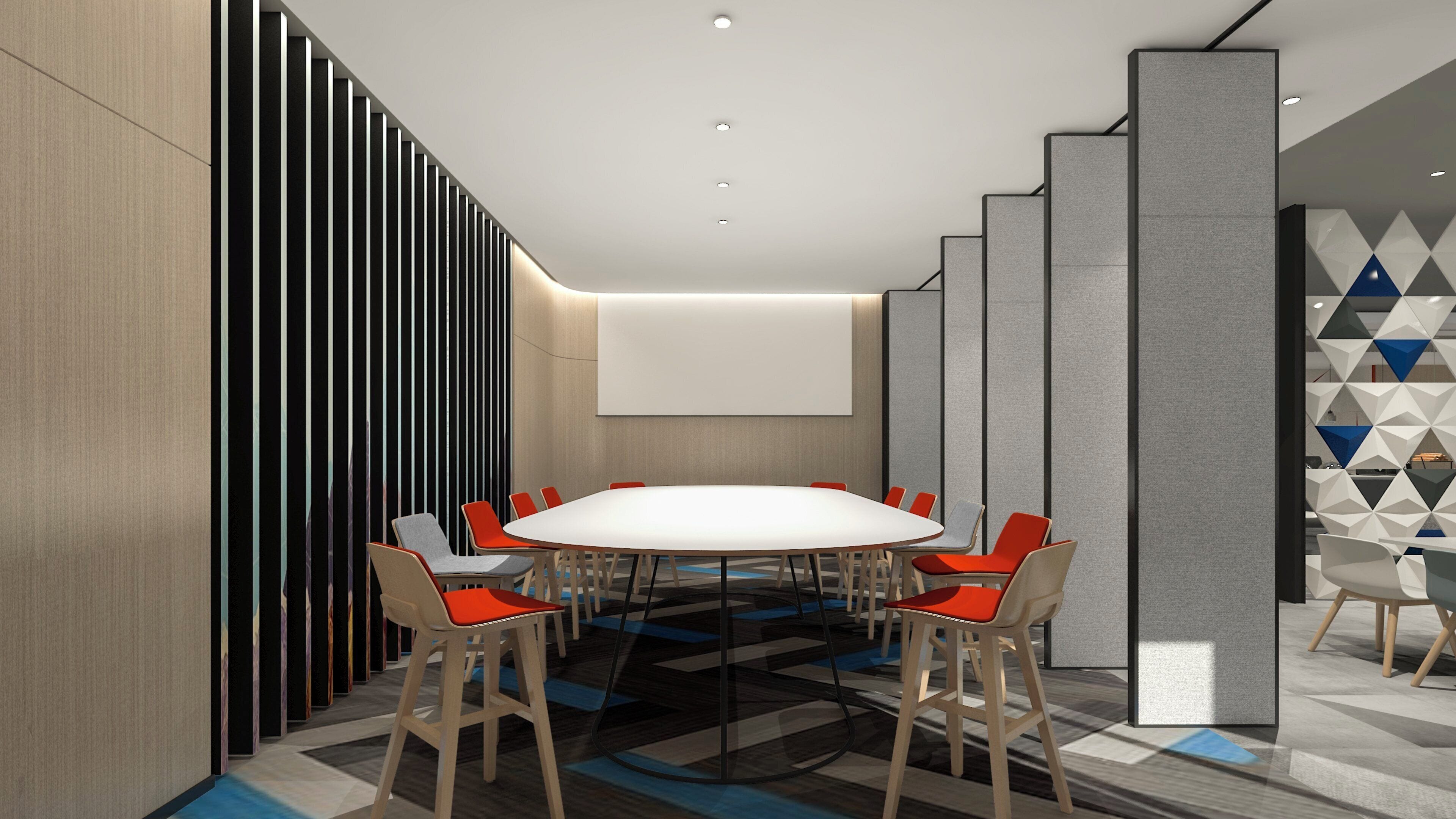 A conference room with a large table, multiple chairs, a projector screen, and a patterned floor.