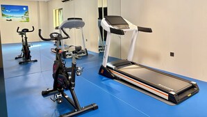 A gym with exercise equipment including a treadmill, stationary bikes, and a rowing machine. - Holiday Inn Express Sanya Bay by IHG (Sanya)