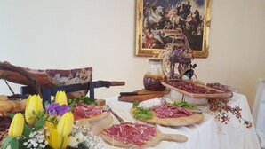 A table with various food items and a painting in the background. - La Villa Del Colle (Monte San Giovanni Campano)
