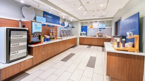 A modern breakfast area with a yogurt, eggs, and milk dispenser, a cereal section, and a bakery counter. - Holiday Inn Express & Suites Nashville North - Springfield by IHG (Springfield)