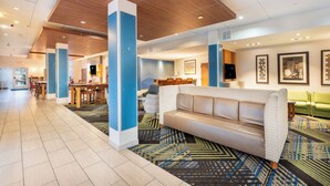 A spacious lobby with a modern design, featuring a central seating area, a dining area, and a reception desk. - Holiday Inn Express & Suites Nashville North - Springfield by IHG (Springfield)