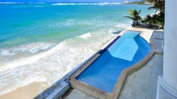 Outdoor pool, an infinity pool, pool loungers