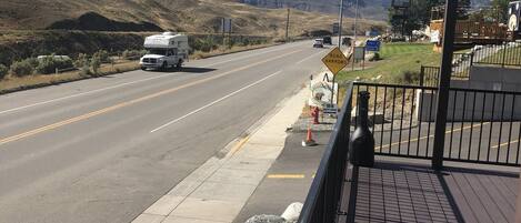 A road with a sign for 'Road Narrowings' and a fire hydrant.