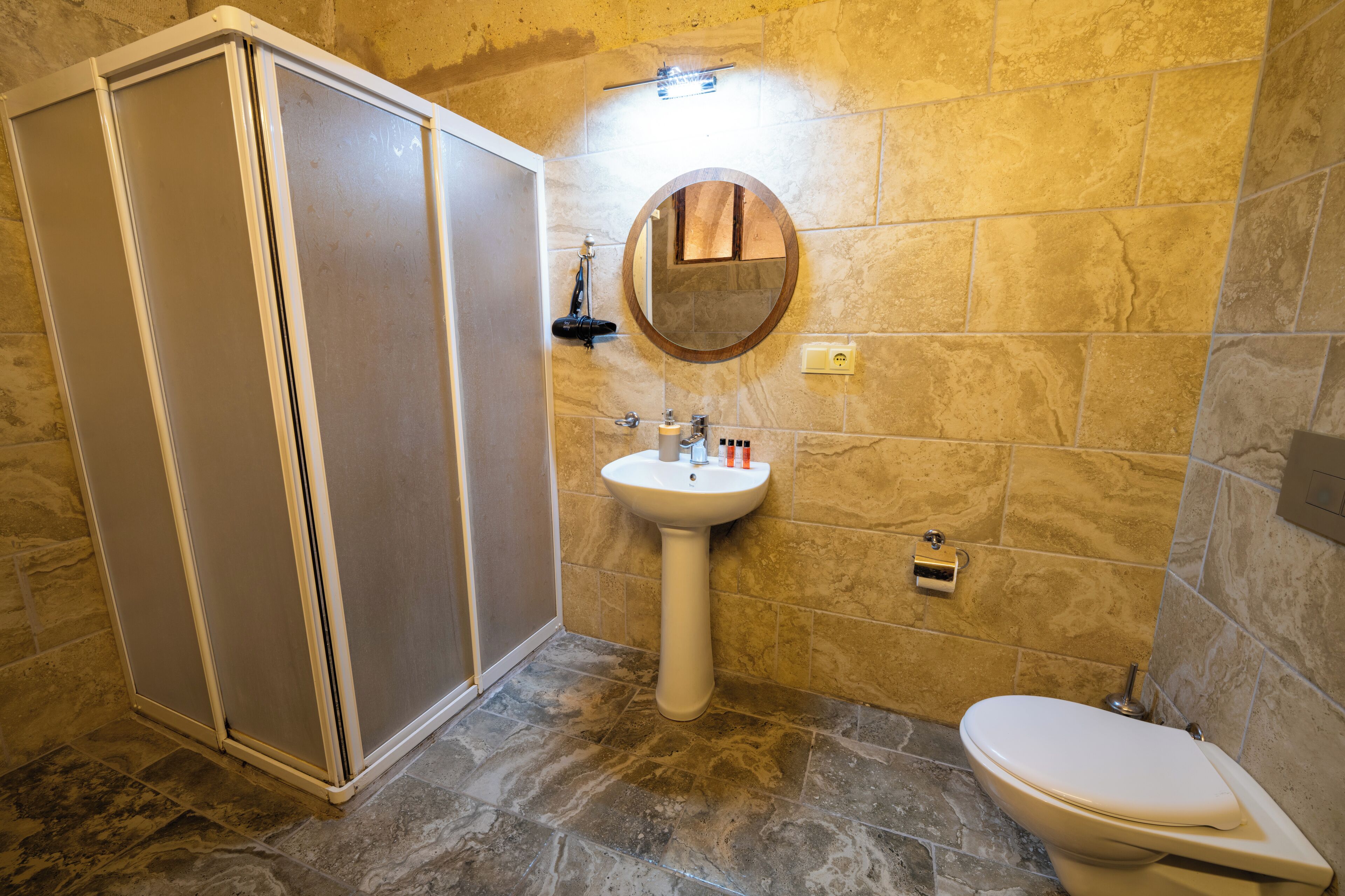 Un baño con ducha, lavabo e inodoro.