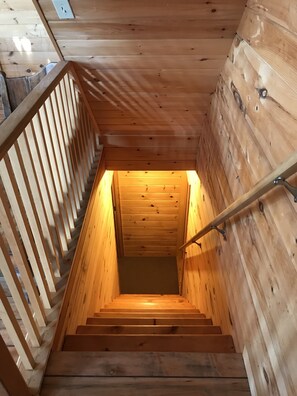 Staircase leads to an upper floor with a handrail for support.