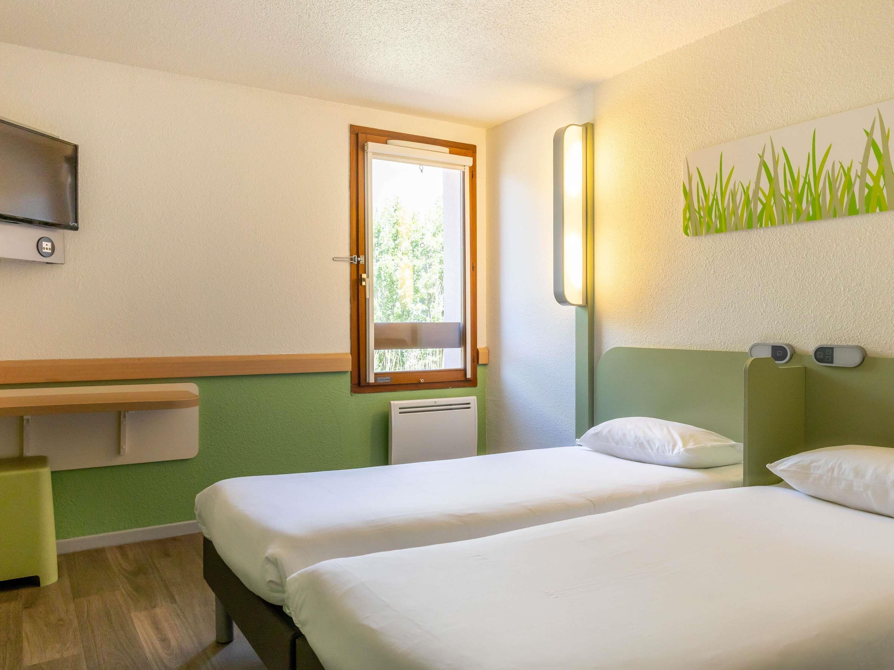 Premium bedding, desk, laptop workspace, blackout drapes