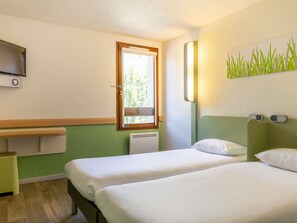 Premium bedding, desk, laptop workspace, blackout drapes