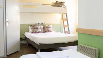 A bunk bed room with a ladder, a bedside table, and a door.