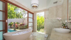 A modern bathroom with a freestanding bathtub, a sink, and a large mirror. - 1BR Villa, DAILY HOUSE KEEPING! - W/Swimming Pool! (Seminyak)