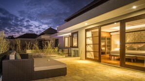 A modern house with a glass door leading to a bedroom with a bed and a desk. - 2BR Villa, Near Padma Beach - W/DAILY HOUSE KEEPING!  (Seminyak)