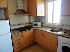 Fridge, microwave, coffee/tea maker, cookware/dishes/utensils