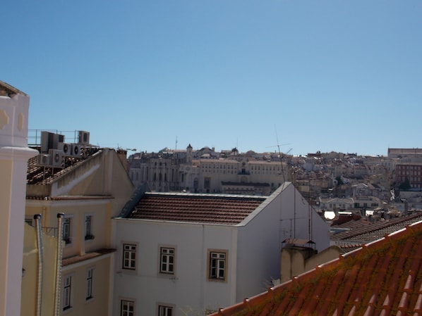 A cityscape with buildings, some with visible balconies and windows.