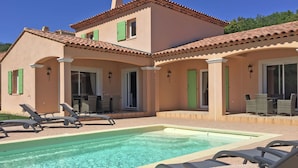 A poolside area with lounge chairs and a pool.