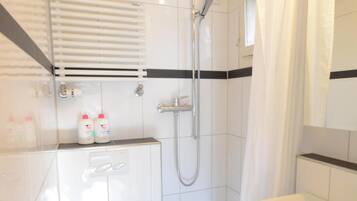 Shower, hair dryer, towels, toilet paper