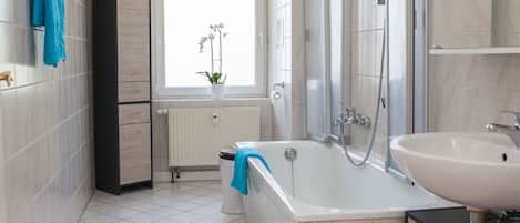 Combined shower/tub, hair dryer, towels, soap