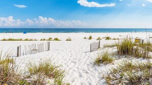 A sandy beach with a clear sky and a few clouds. - "Romar House at Beachside"Great Location-Private Heated Pool"ALVacationRentals" (Orange Beach)