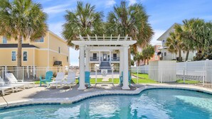 A pool area with lounge chairs, a covered seating area, and palm trees. - "Romar House at Beachside"Great Location-Private Heated Pool"ALVacationRentals" (Orange Beach)