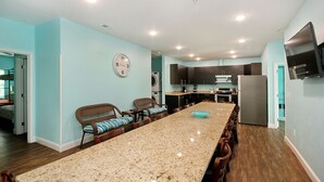A spacious kitchen with a long island, dark wooden cabinets, and a built-in oven. - 8 Private Bedrooms+Bathrooms! HUGE POOL+KITCHEN+PRIVATE RETREAT By the Beach!!! (Myrtle Beach)