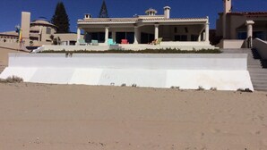 A large house with a covered patio and a set of stairs leading to the entrance. - Beach front in Rocky Point (Puerto Penasco)