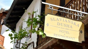 A sign for Slavianska Dusha Hotel & Restaurant, indicating it has been in operation since 2000.