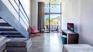 A modern interior with a staircase, seating area, and a television. - Club Marmara Doreta Beach Resort & Spa All Inclusive (Rhodes)