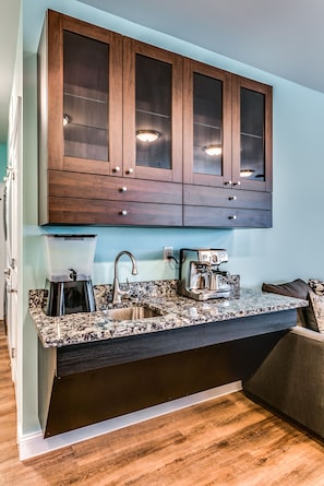 Enjoy cooking in this kitchen with a coffee maker, stainless steel sink, and granite countertop.