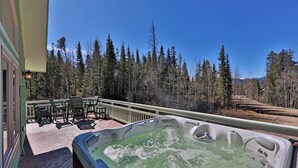 A hot tub on a wooden deck with a view of a forest and mountains. - Breathtaking Mountain Sunsets! 6BR, 3 King Beds, Hot Tub, Shuttle, Sleeps 16+ (Fraser)