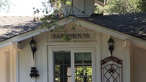 A white building with a sign reading "FARMHOUSE" above the door. - Charming Santa Ynez farmhouse (Santa Ynez)