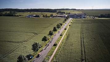 An aerial view of a road with vehicles and buildings in a rural setting.