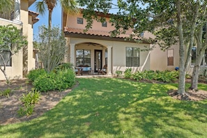 A residential building with a covered patio, a lawn, and mature trees. - Two Golf Carts ~ Near Golf Course ~ Community Pool (Miramar Beach)