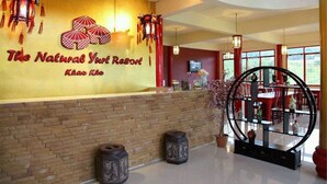 A reception area with a wall sign reading "The Natural Yoga Resort Khao Kho". - The Natural Yurt Resort at Khao Kho (Khao Kho)