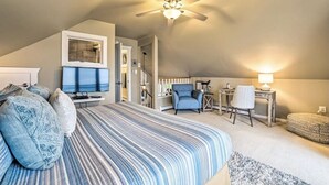 A bedroom with a large bed, a ceiling fan, a desk with a chair, and a television. - July 25th - Aug. 1st Available! (Charlevoix)