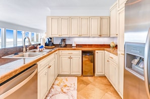 Enjoy cooking in this well-equipped kitchen with a double sink, coffee maker, and dishwasher.