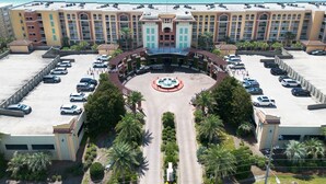 A hotel with a central courtyard, parking area, and a view of the ocean. - Ocean Front 3 BR/3BA/Ground Floor walk out Updated (Fort Walton Beach)