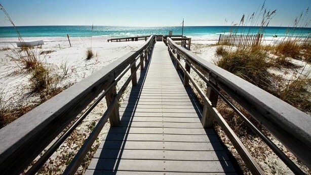 A wooden boardwalk leading to a beach with clear skies. - Ocean Front 3 BR/3BA/Ground Floor walk out Updated (Fort Walton Beach)